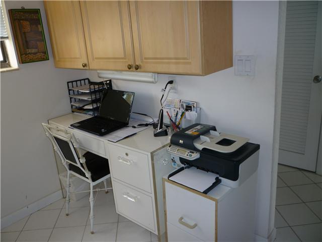 4345 Trevi Court, Unit 208 Lake Worth, FL 33467 - Photo 4 of 20 a kitchen with a sink cabinets and stove top oven
