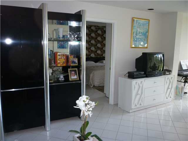 4345 Trevi Court, Unit 208 Lake Worth, FL 33467 - Photo 6 of 20 a room with cabinets and flat screen tv