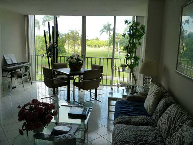4345 Trevi Court, Unit 208 Lake Worth, FL 33467 - Photo 7 of 20 a living room with furniture and a floor to ceiling window
