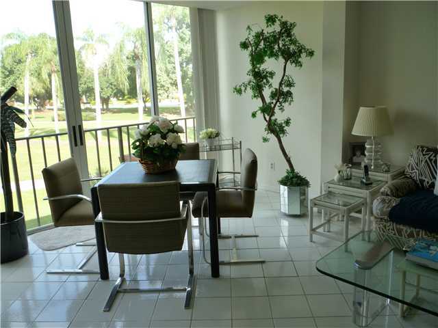 4345 Trevi Court, Unit 208 Lake Worth, FL 33467 - Photo 8 of 20 a view of a dining room with furniture window and outside view