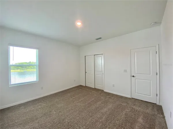 a bathroom with a granite countertop sink toilet a mirror and shower