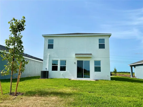 a view of an house with backyard porch and furniture