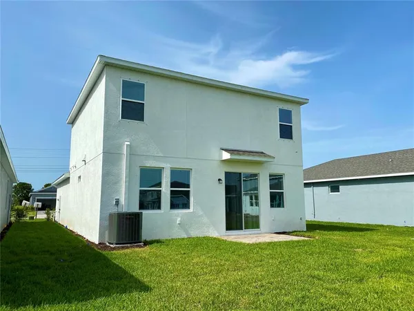 a view of a backyard with table and chairs