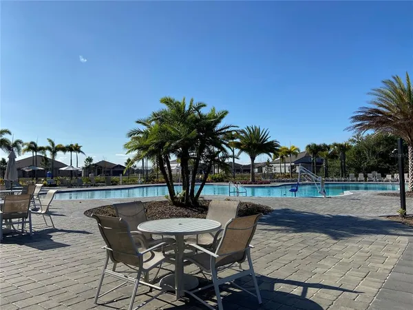 a view of a yard with table and chairs under an umbrella