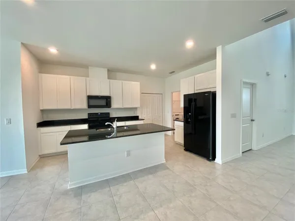 a kitchen with stainless steel appliances a refrigerator stove microwave and cabinets