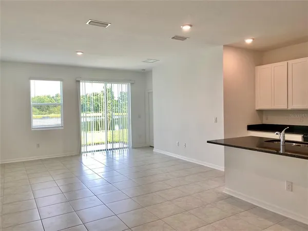 a kitchen with granite countertop a sink and a stove