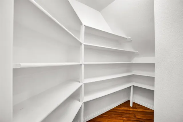 a view of walk in closet with empty racks