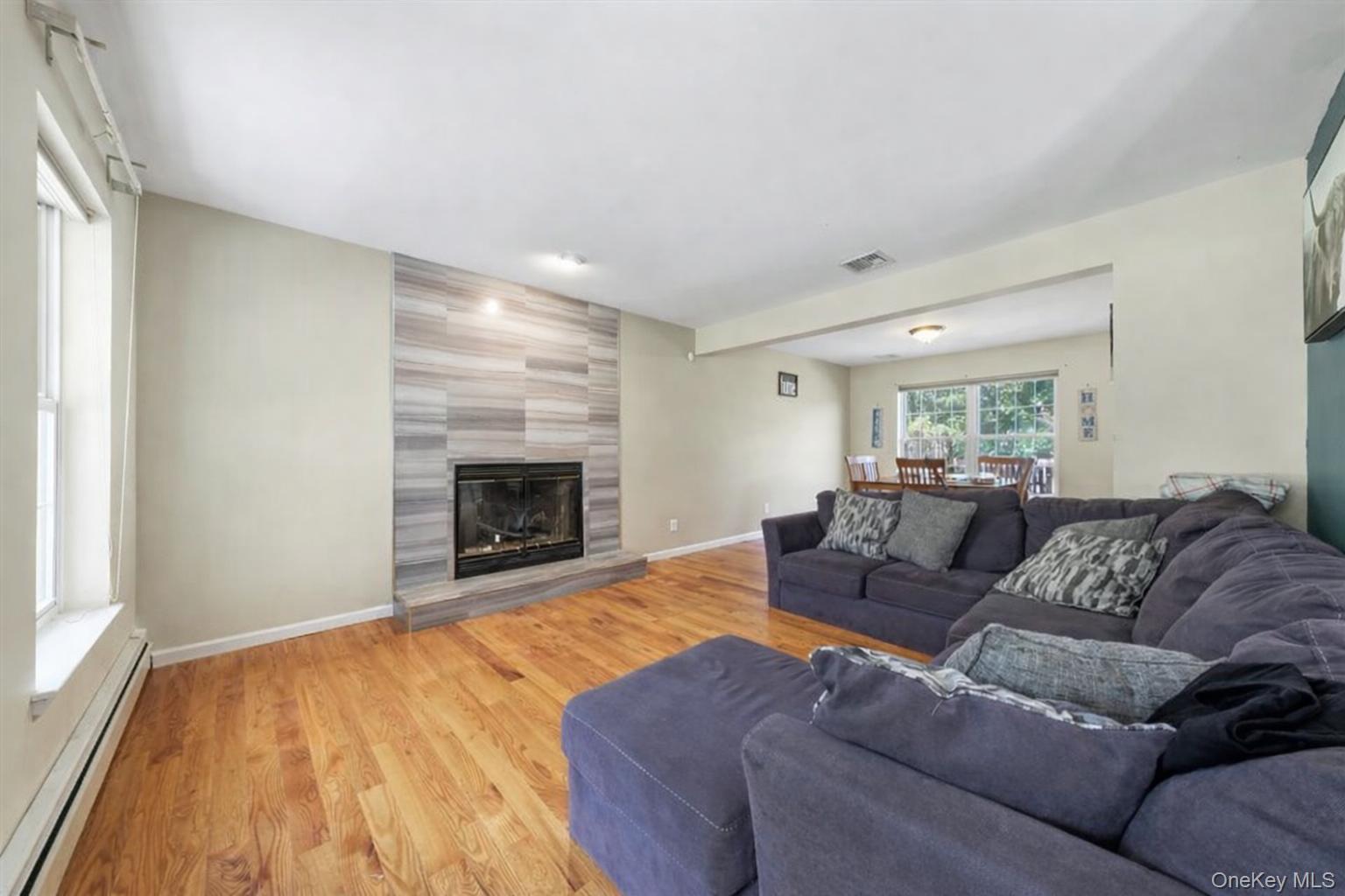 220 Prospect Road Monroe, NY 10950 - Photo 18 of 42 Living area with a baseboard heating unit, wood finished floors, and a fireplace