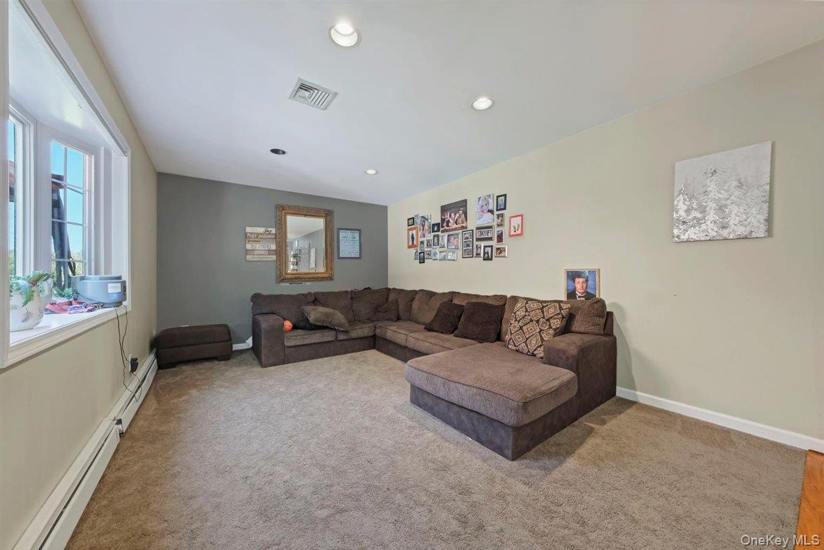 220 Prospect Road Monroe, NY 10950 - Photo 19 of 42 Living room with light colored carpet, a baseboard radiator, and recessed lighting