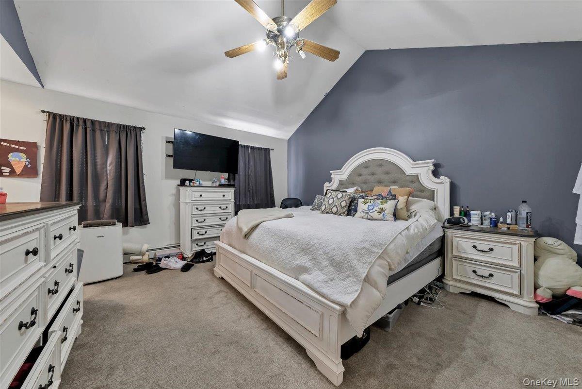 220 Prospect Road Monroe, NY 10950 - Photo 23 of 42 Bedroom featuring vaulted ceiling, light colored carpet, and a ceiling fan