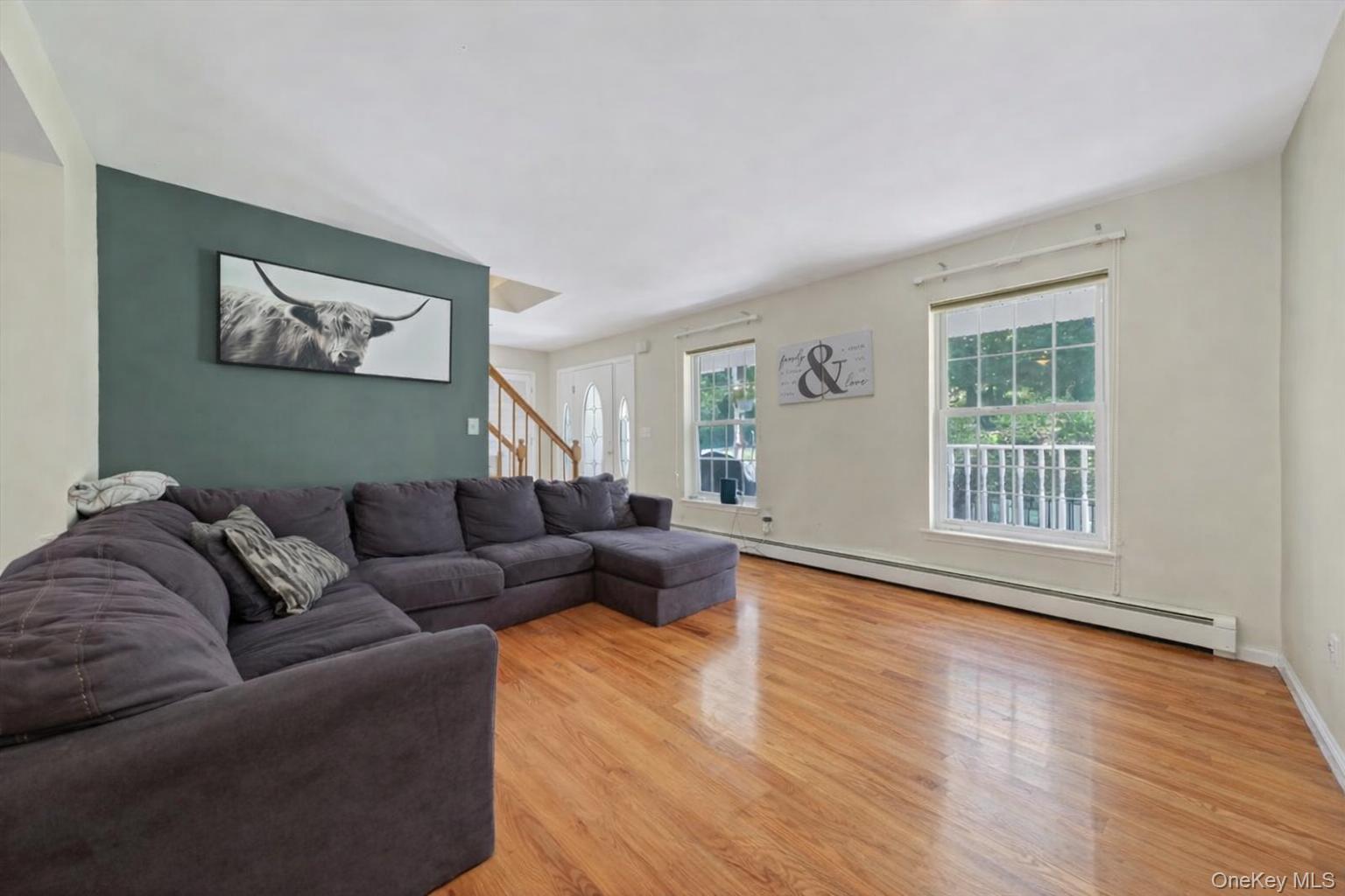 220 Prospect Road Monroe, NY 10950 - Photo 32 of 42 Living room with light wood-style flooring, a baseboard radiator, and stairway