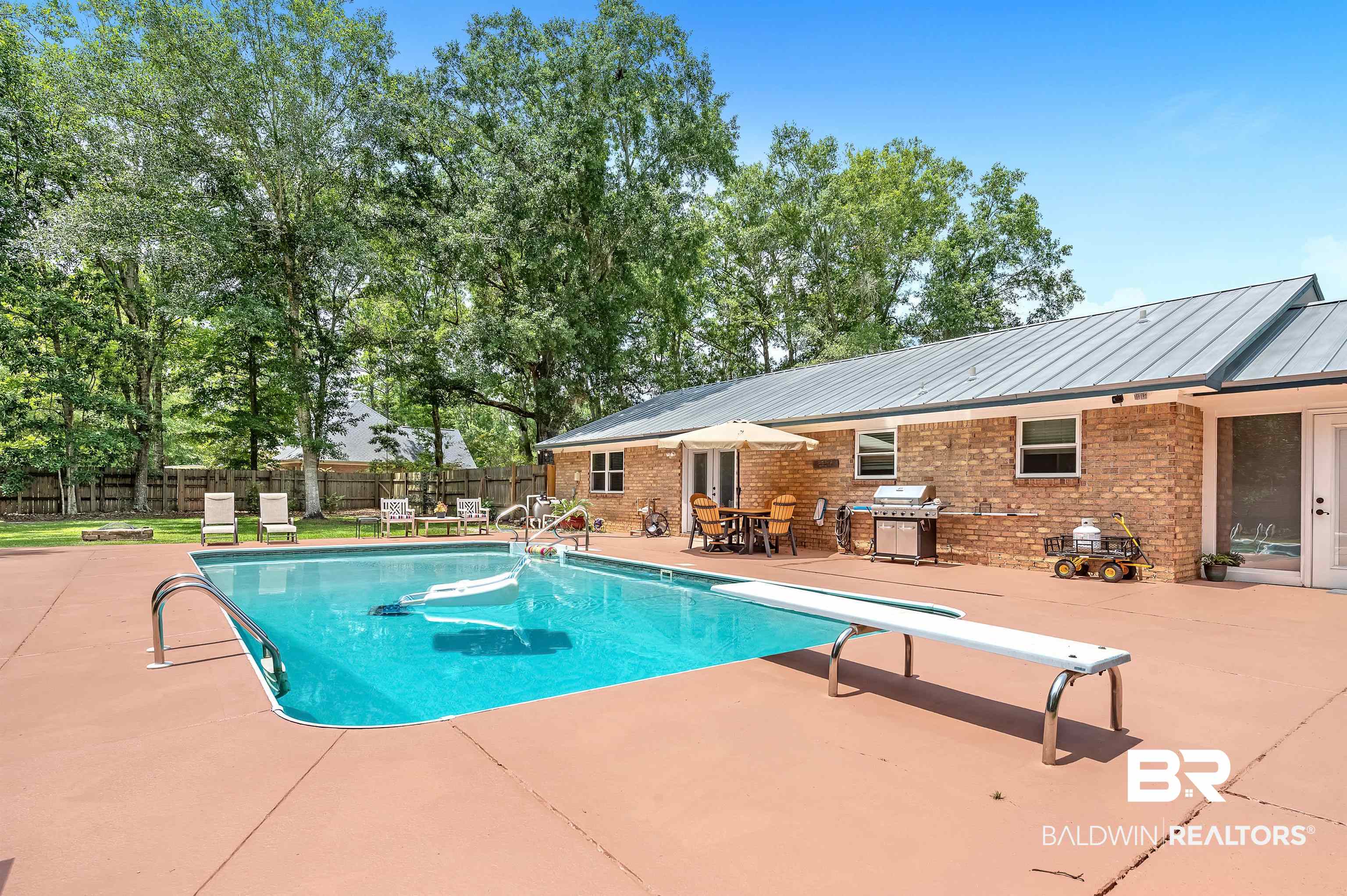 24551 Wolf Bay Drive Foley, AL 36535 - Photo 11 of 59 View of swimming pool featuring a patio, a fenced backyard, a grill, and a diving board