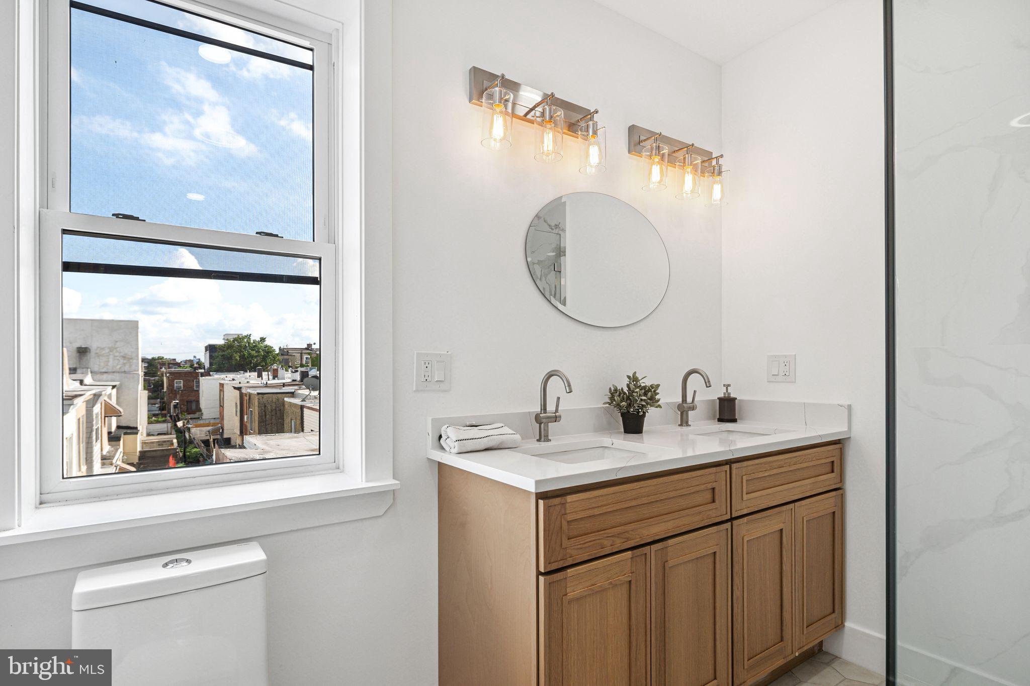 908 Reed Street Philadelphia, PA 19147 - Photo 21 of 33 a bathroom with a sink and a mirror with window