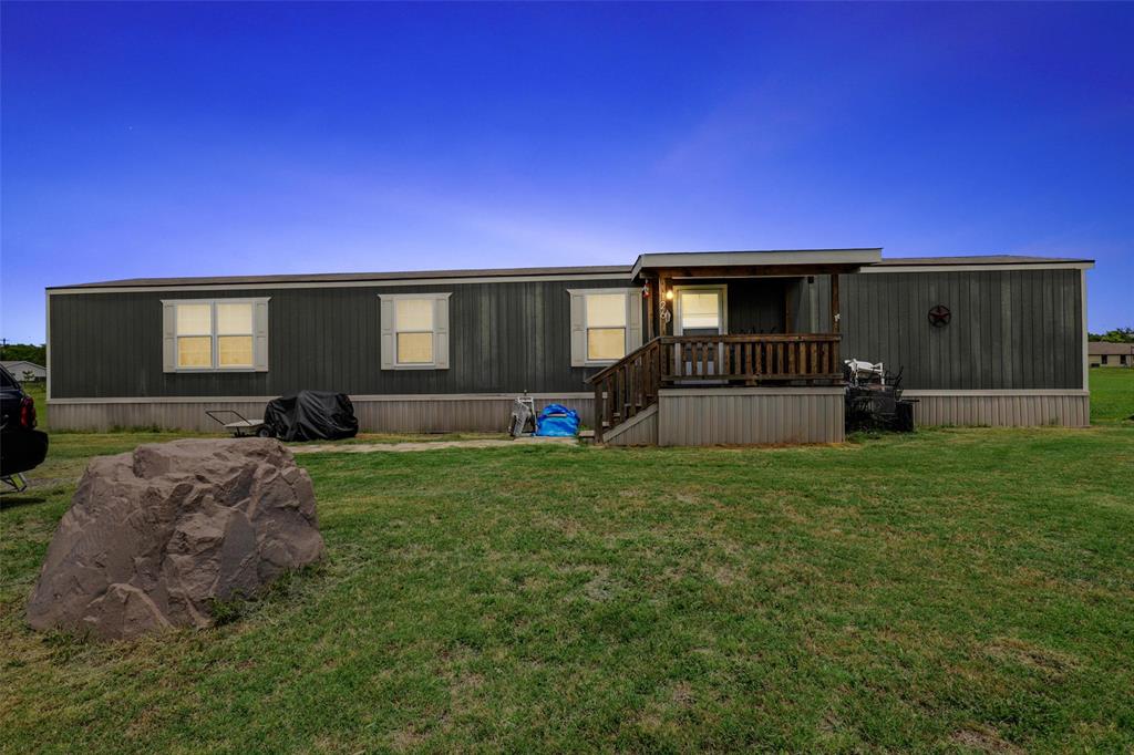 a front view of a house with swing and slide