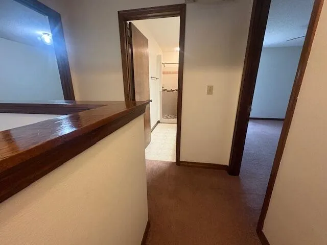 a view of hallway with wooden floor