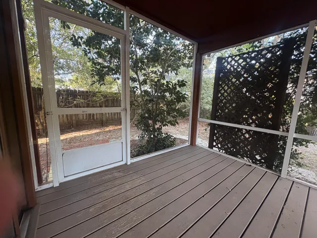 a view of a balcony with wooden floor