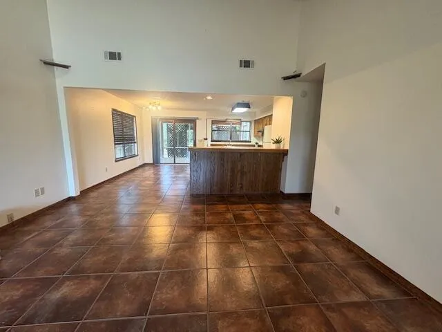 a view of a livingroom with kitchen and furniture