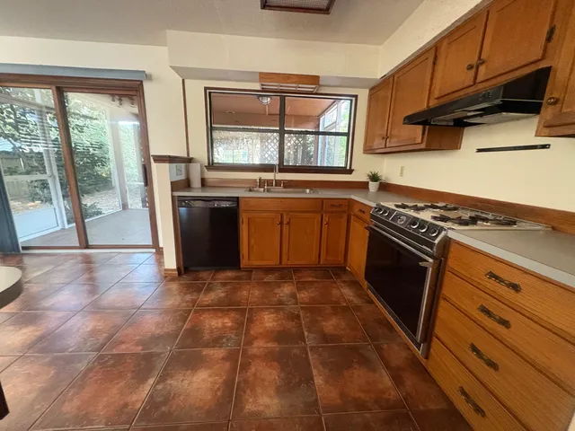 a kitchen with a stove a sink and a refrigerator