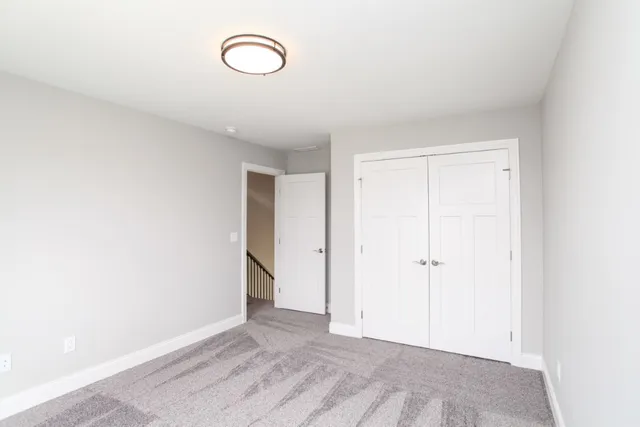 a view of a room with wooden floor and window