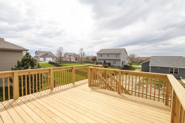 a view of a balcony with wooden floor and fence