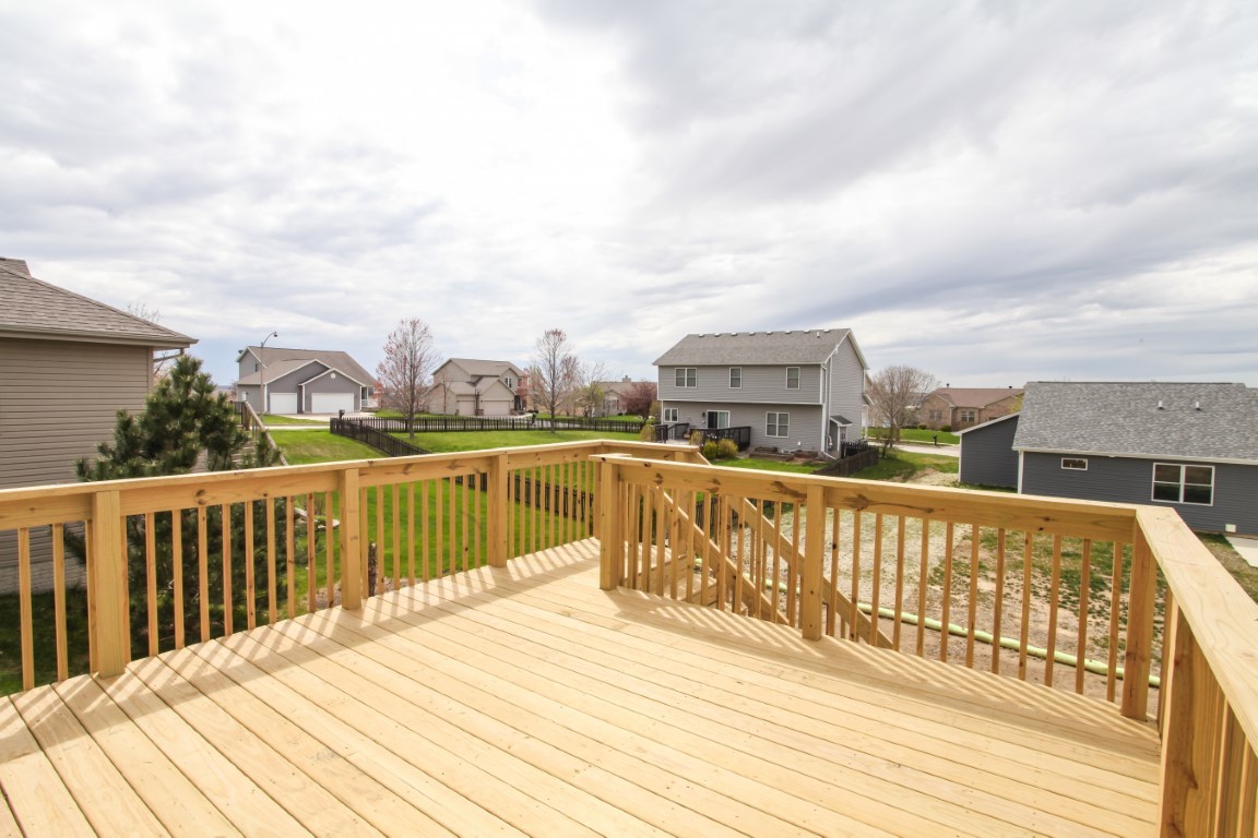 21 Fedor Circle Bloomington, IL 61705 - Photo 32 of 40 a view of a balcony with wooden floor and fence