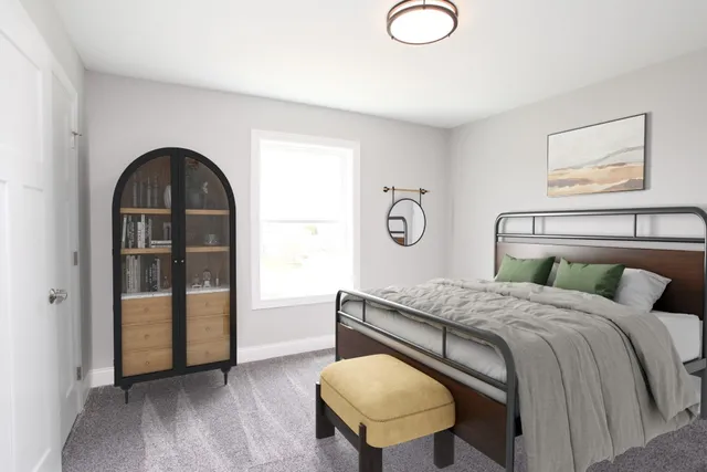 a bedroom with a bed and a painting on the wall