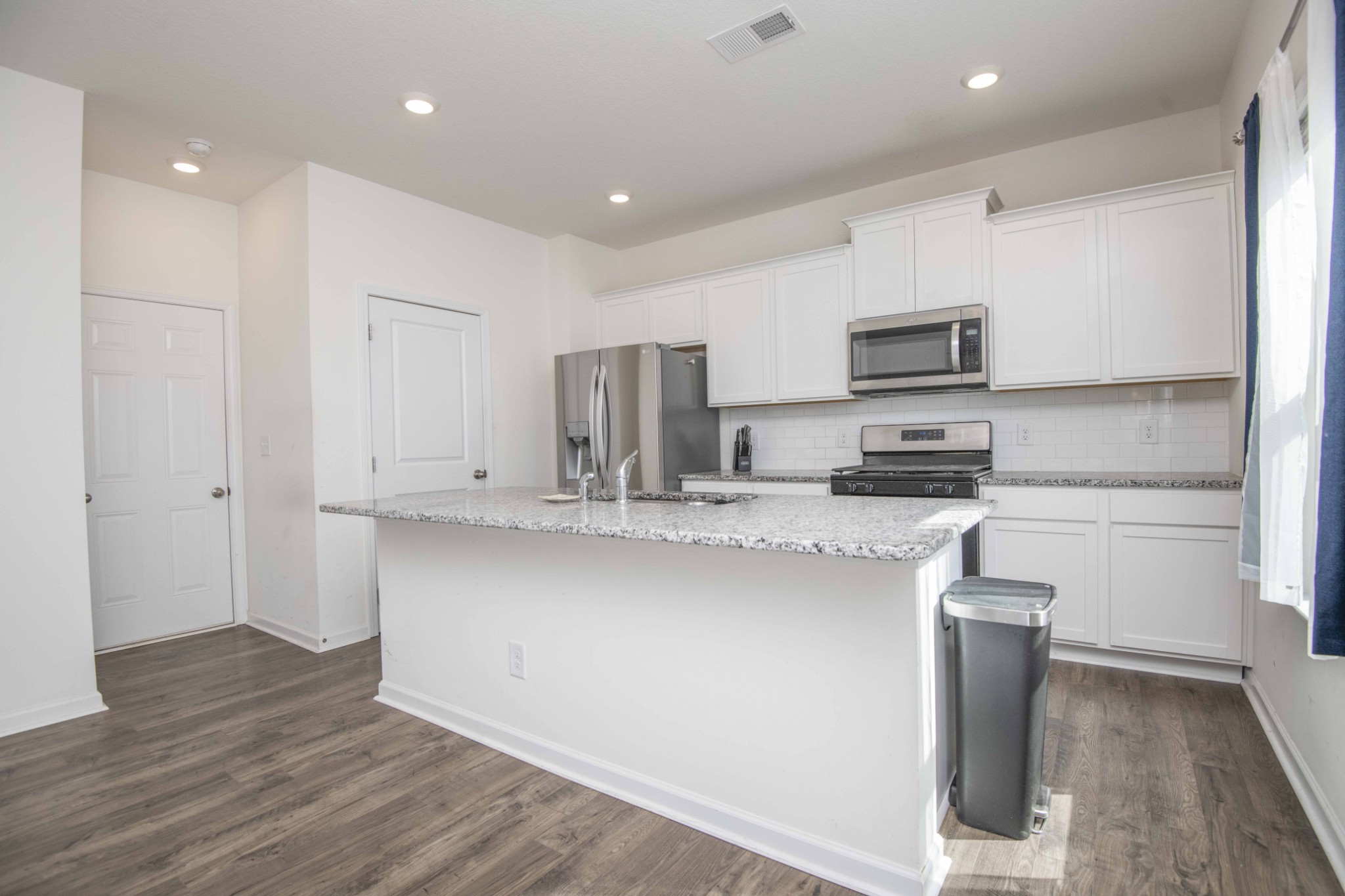 514 Cliff Street Morristown, TN 37814 - Photo 8 of 45 a kitchen with kitchen island white cabinets and stainless steel appliances