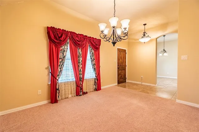 a view of a room with projector and a chandelier
