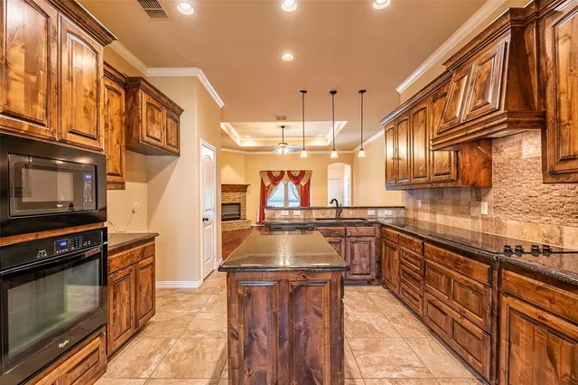 an empty room with ceiling fan and window