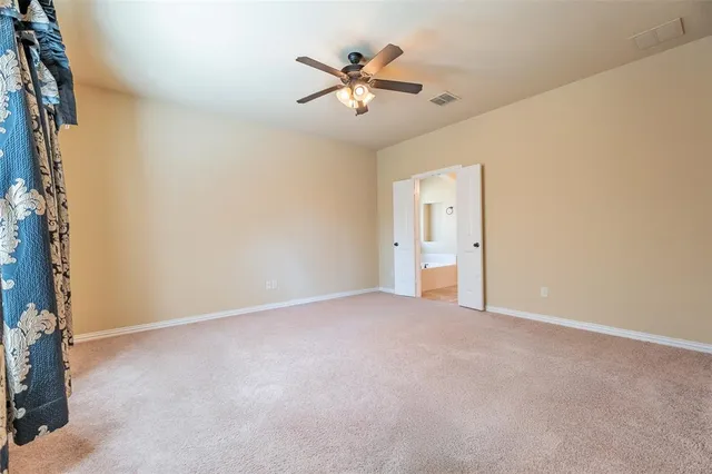 a spacious bathroom with a tub sink and mirror
