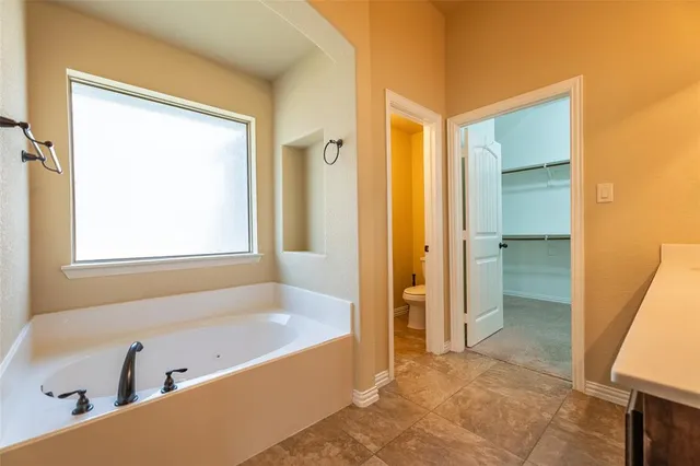 a spacious bathroom with a granite countertop sink a mirror and a