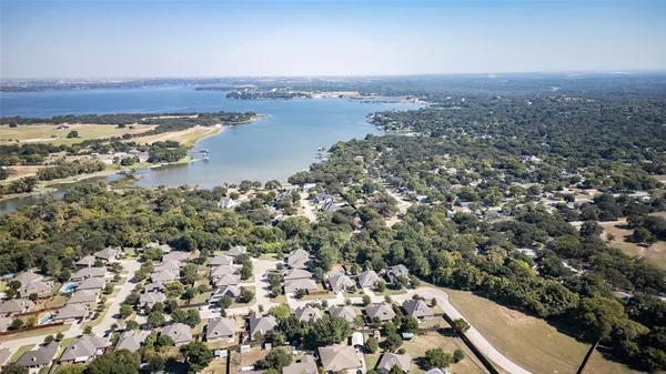 an aerial view of a house with a lake view