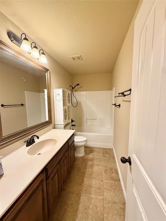 409 Corriente Trail Azle, TX 76020 - Photo 20 of 36 a bathroom with a double vanity sink toilet mirror and shower