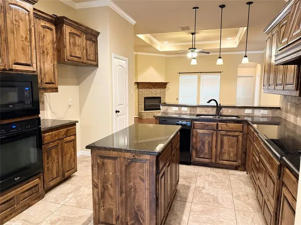 a kitchen with stainless steel appliances granite countertop a sink and a stove