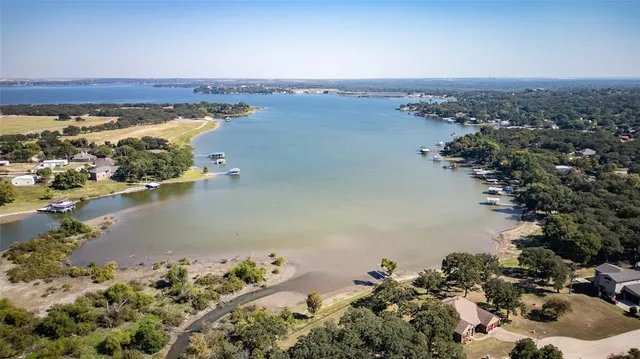 an aerial view of a house with a yard and trees