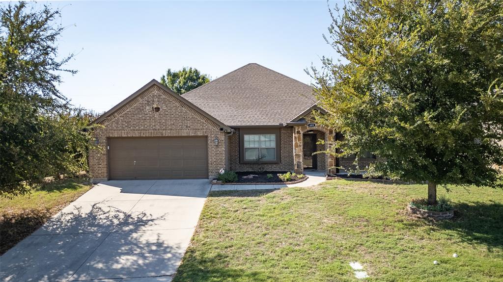 409 Corriente Trail Azle, TX 76020 - Photo 31 of 36 a front view of a house with a yard and garage