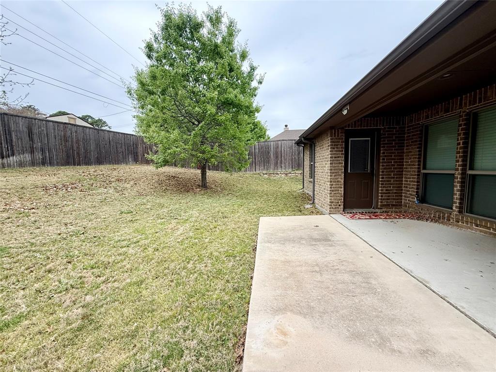 409 Corriente Trail Azle, TX 76020 - Photo 32 of 36 a backyard of a house with table and chairs