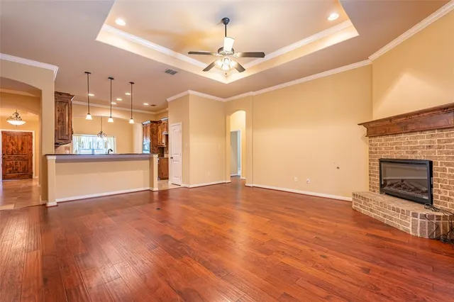 a view of a living room with wooden floor