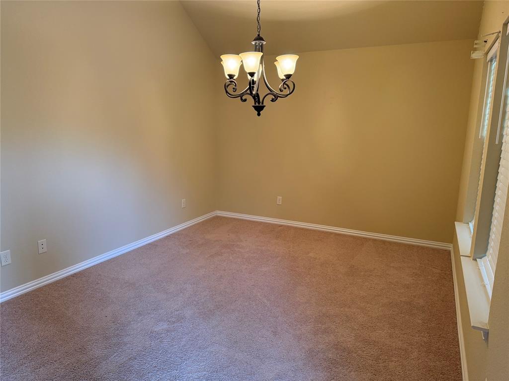 409 Corriente Trail Azle, TX 76020 - Photo 6 of 36 a view of a room with a hanging light and stainless steel appliances