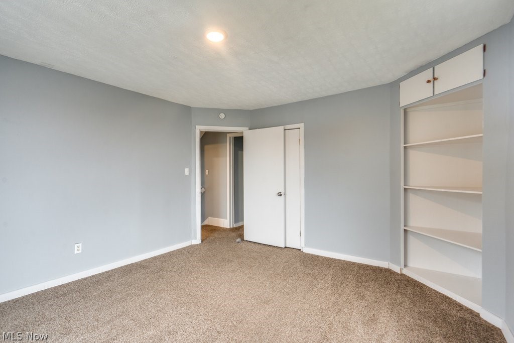 1607 9th Street Southwest Canton, OH 44706 - Photo 27 of 41 Room featuring light gray walls, textured carpet flooring, and a recessed ceiling light