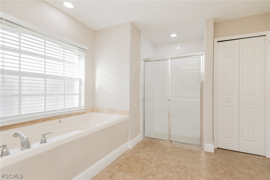 1018 Card Street East Lehigh Acres, FL 33974 - Photo 11 of 16 a bathroom with a bathtub and a shower