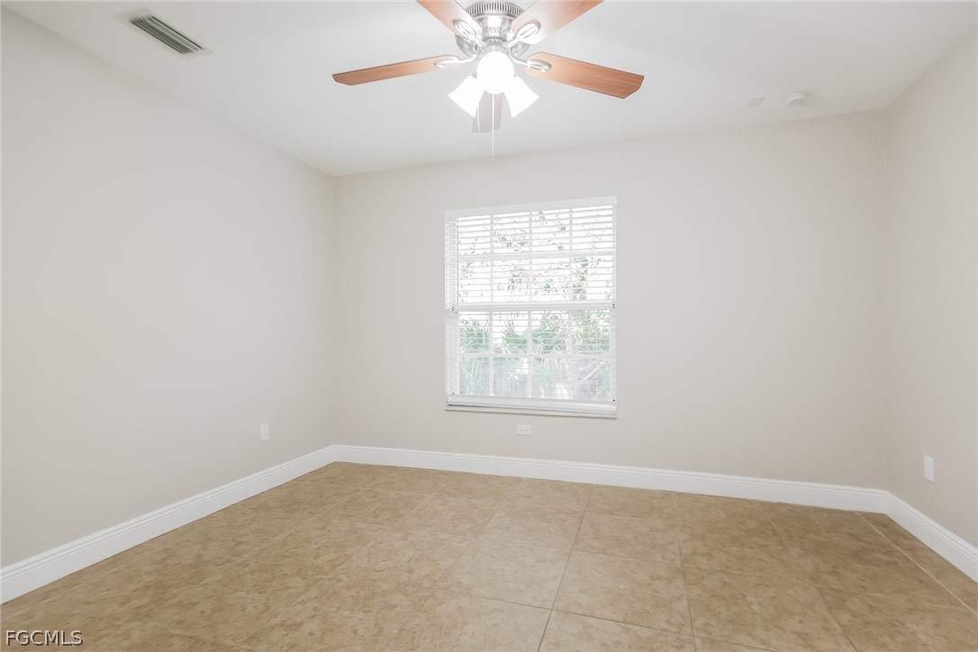 1018 Card Street East Lehigh Acres, FL 33974 - Photo 12 of 16 an empty room with windows and fan