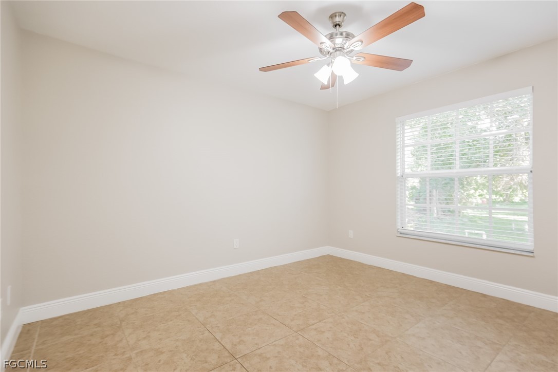 1018 Card Street East Lehigh Acres, FL 33974 - Photo 13 of 16 an empty room with windows and fan