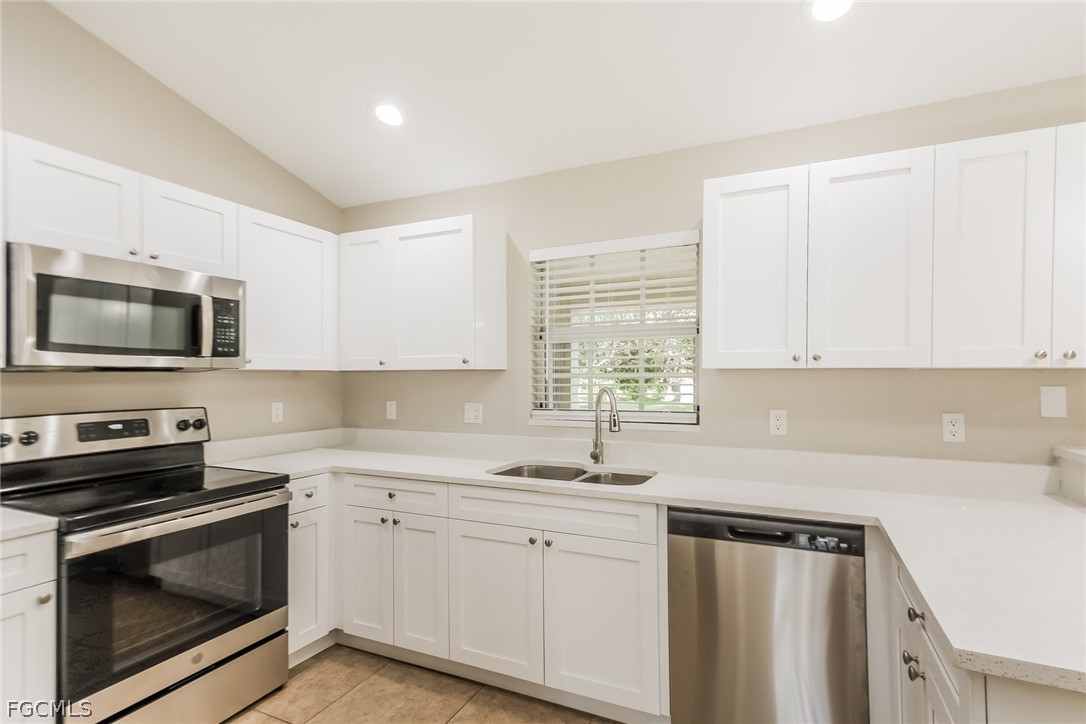 1018 Card Street East Lehigh Acres, FL 33974 - Photo 6 of 16 a kitchen with a sink stove and microwave