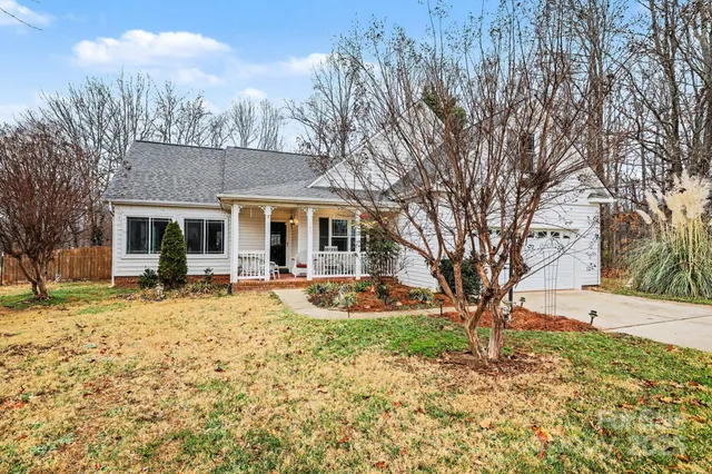 a backyard of a house with garden and outdoor seating
