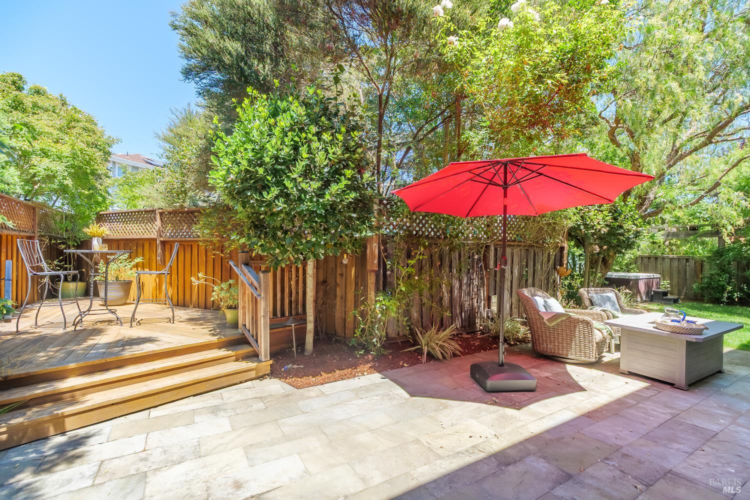 68 Pinheiro Circle Novato, CA 94945 - Photo 27 of 82 Step outside to a private backyard featuring a spacious patio, elevated sun deck, and multiple areas for outdoor entertaining. Mature landscaping and a hot tub create a peaceful setting to relax or host family and friends.
