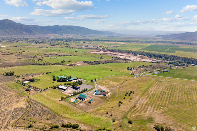6117 North Rocky Ridge Road Peoa, UT 84061 - Photo 82 of 82 Expansive rural property featuring a main residence, multiple auxiliary buildings, a paved driveway, and established green pastures