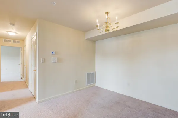 a view of a chandelier in big room and chandelier
