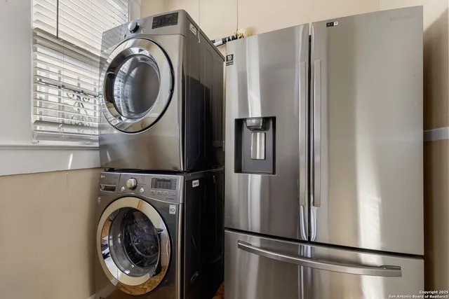 a kitchen with stainless steel appliances a stove a table and chairs