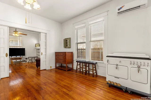 a view of a a dining room with furniture window and wooden floor